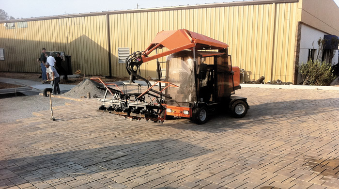 Paver laying machine laying Belgard Commercial interlocking concrete pavers.