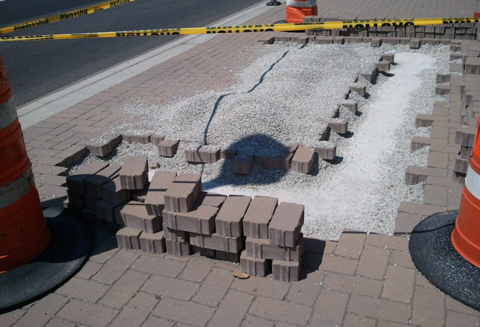 Belgard interlocking permeable pavers being removed to allow for underground repair.