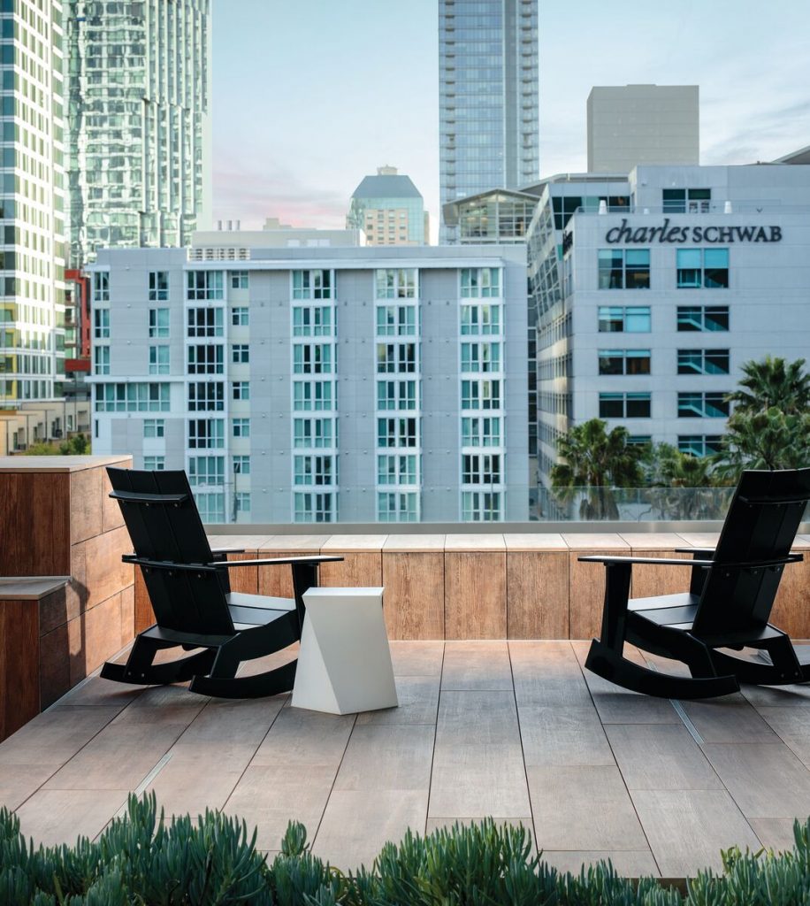 Urban rooftop with two rocking chairs on top of Belgard rooftop pavers
