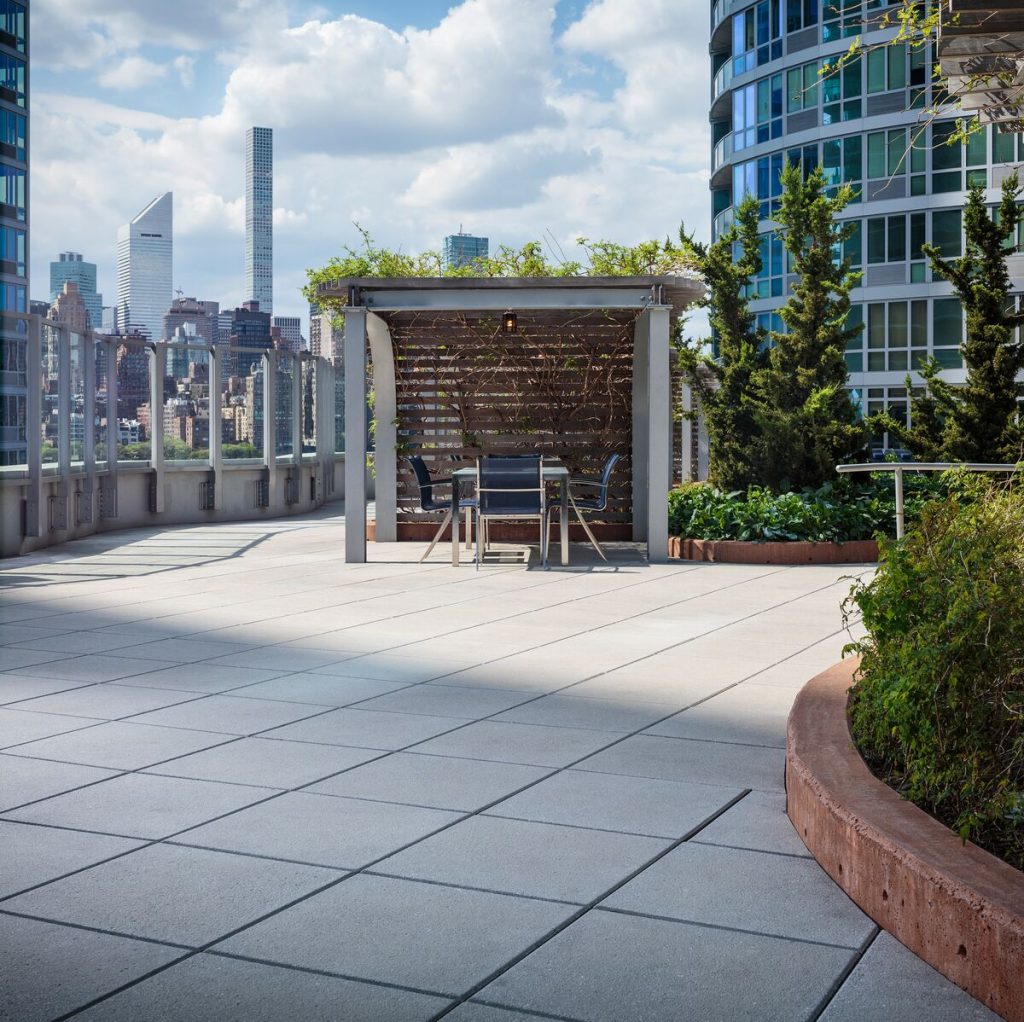 New York City rooftop featuring a pergola and Belgard pavers